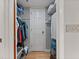 Functional walk-in closet with ample hanging space and shelving for organized storage of clothing and accessories at 19727 Gulf Blvd # 209, Indian Shores, FL 33785