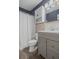 Cozy bathroom includes updated vanity, cabinet storage, and shower at 2050 Nigels Dr, Dunedin, FL 34698