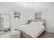 Bright bedroom with many windows, neutral colors, and a plush bed at 2050 Nigels Dr, Dunedin, FL 34698