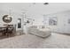 Bright and airy living room featuring modern decor, a plush sofa, dining area and lots of natural light at 2050 Nigels Dr, Dunedin, FL 34698