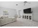 Stylishly decorated living room with a large TV, comfortable seating, and bright decor, creating a welcoming space at 2050 Nigels Dr, Dunedin, FL 34698