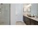 Bathroom featuring double vanity with granite countertop and tiled walk-in shower at 29912 Rusco Ct, Wesley Chapel, FL 33545