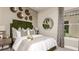 Stylishly decorated bedroom featuring an eye-catching green headboard and a decorative mirror accent at 29912 Rusco Ct, Wesley Chapel, FL 33545