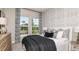Bedroom featuring large windows, patterned wallpaper, and contemporary furnishings at 29912 Rusco Ct, Wesley Chapel, FL 33545