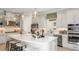 Modern kitchen with white cabinets, stainless steel appliances, and center island at 29912 Rusco Ct, Wesley Chapel, FL 33545