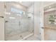 Modern bathroom featuring marble-tiled shower, glass door, and a convenient built-in niche at 3021 W Ballast Pt # 2, Tampa, FL 33611