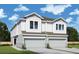 Charming two-story townhome featuring a white exterior and a two-car garage at 3021 W Ballast Pt # 2, Tampa, FL 33611