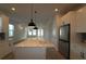 Modern kitchen with stainless steel appliances, island, and open floor plan at 3021 W Ballast Pt # 2, Tampa, FL 33611