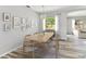 Dining room with wood-look floors, modern light fixture, and a view of the backyard at 3023 Green Acres Ave, Largo, FL 33771