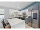 Modern kitchen featuring white upper cabinets, grey lower cabinets, stainless steel appliances, and quartz countertops at 3525 65Th Avenue E Cir, Sarasota, FL 34243