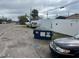 Picture of the street view next to a vacant lot with a dumpster and cars in the shot at 4104 W Osborne Ave, Tampa, FL 33614
