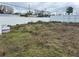 Image of a vacant lot with trash on it, enclosed with a white fence at 4104 W Osborne Ave, Tampa, FL 33614