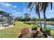 Beautiful landscaping in the back yard offers relaxing views of the adjacent pond at 412 Arborview Ln, Venice, FL 34292