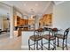 Kitchen with bar seating and stainless steel appliances and wood cabinetry at 412 Arborview Ln, Venice, FL 34292