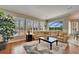 Inviting living room with large windows, plantation shutters, and comfortable seating at 412 Arborview Ln, Venice, FL 34292