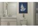 Stylish bathroom featuring a white vanity, framed fern print, and a glass-enclosed shower at 4511 S Manhattan Ave # 28, Tampa, FL 33611