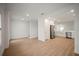 Open-concept living space featuring wood-look floors, white walls, and a modern kitchen nearby at 4511 S Manhattan Ave # 28, Tampa, FL 33611