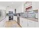 Beautiful kitchen with stainless steel appliances, tiled backsplash, and ample counter space at 5001 Shetland Ave, Tampa, FL 33615