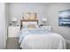 Cozy bedroom featuring a queen-sized bed with blue accents, bedside tables, and decorative wall art at 5024 124Th E Ave, Parrish, FL 34219