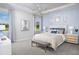 Serene bedroom with soft blue accents, stylish furnishings, and large windows providing ample natural light at 5024 124Th E Ave, Parrish, FL 34219
