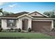 Charming single-story home featuring a well-manicured lawn, covered entryway, and a two-car garage at 5024 124Th E Ave, Parrish, FL 34219