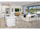Open-concept living area with a kitchen island, comfortable seating, and a picturesque view of the outdoors at 5024 124Th E Ave, Parrish, FL 34219