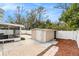 View of the backyard, patio, screened in porch and storage shed at 5640 Tughill Dr, Tampa, FL 33624