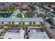 Aerial view of community condos showing the surrounding neighborhood, pool, and adjacent residential homes at 6033 113Th St # 213, Seminole, FL 33772