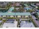 Aerial view of community condos showing the surrounding neighborhood, pool, and adjacent residential homes at 6033 113Th St # 213, Seminole, FL 33772