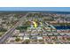 Aerial view of community condos showing the surrounding neighborhood, pond, and community pool at 6033 113Th St # 213, Seminole, FL 33772