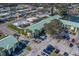 An aerial shot of a condo building with a well-maintained parking lot and landscaped grounds at 6033 113Th St # 213, Seminole, FL 33772