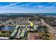 Aerial view of condos with green roofs, community ponds, parking, and surrounding neighborhood at 6033 113Th St # 213, Seminole, FL 33772