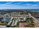 Community aerial view featuring residential buildings, ponds, parking and a glimpse of the ocean at 6033 113Th St # 213, Seminole, FL 33772