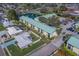 Aerial view of the community with lush landscaping, pond, and ample parking spaces at 6033 113Th St # 213, Seminole, FL 33772