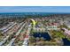An aerial shot showcases the community's condo buildings, pond with fountain, and the surrounding neighborhood at 6033 113Th St # 213, Seminole, FL 33772