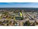 Aerial view of condos with green roofs, community ponds, and surrounding neighborhood at 6033 113Th St # 213, Seminole, FL 33772