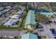 Aerial view of condo buildings with green roofs, surrounded by neighborhood and pond at 6033 113Th St # 213, Seminole, FL 33772