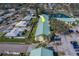 Aerial view of property showcasing the building, surrounding landscaping, pond, and parking at 6033 113Th St # 213, Seminole, FL 33772