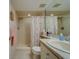 Bright bathroom features a shower and vanity with granite countertops, well lit with soft natural light at 6033 113Th St # 213, Seminole, FL 33772