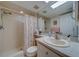 Bright bathroom featuring white granite counters, a shower with curtains, and neutral walls at 6033 113Th St # 213, Seminole, FL 33772