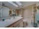 Bright bathroom featuring a large mirror, granite countertop, and shower-tub combination at 6033 113Th St # 213, Seminole, FL 33772