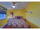 Bright bedroom featuring a comfortable bed and sunny yellow walls for a cheerful ambiance at 6033 113Th St # 213, Seminole, FL 33772