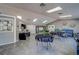 Open clubhouse with tables, sofas, tv and a bulletin board with community information at 6033 113Th St # 213, Seminole, FL 33772