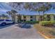 Well-maintained condo exterior featuring a tropical landscape and ample parking space at 6033 113Th St # 213, Seminole, FL 33772