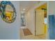 Bright hallway with neutral tones, decorative mirror, and access to various rooms at 6033 113Th St # 213, Seminole, FL 33772