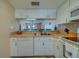 Efficient kitchen space with modern appliances, granite countertops, and a view through to dining area at 6033 113Th St # 213, Seminole, FL 33772