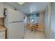 Cozy eat-in kitchen with white appliances, tiled floor, and natural light from the window at 6033 113Th St # 213, Seminole, FL 33772