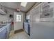 A clean kitchenette features basic appliances with an exit door and community instructions posted at 6033 113Th St # 213, Seminole, FL 33772