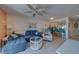 Comfortable living room featuring a ceiling fan, and an adjacent breakfast bar area at 6033 113Th St # 213, Seminole, FL 33772