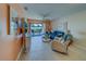 Cozy living room with tile floors, fan, sliders to patio, and comfortable seating at 6033 113Th St # 213, Seminole, FL 33772